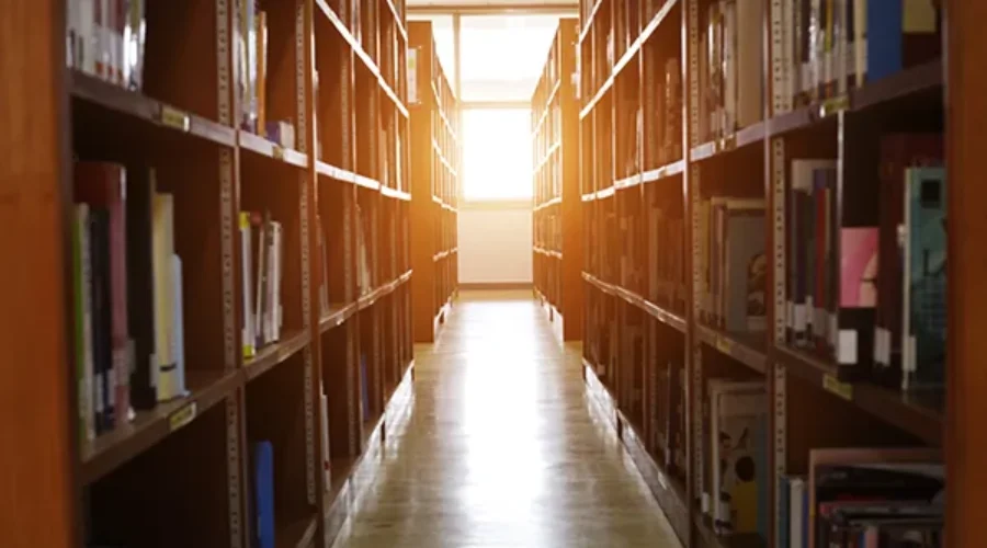 Library Shelves with a bright light at the end of the aisle